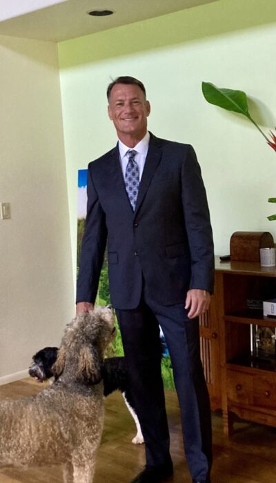 Mark D. Clement Image of Mark D. Clement with his office dog